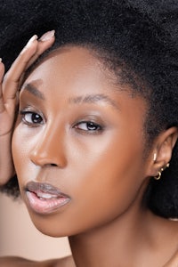 a woman with afro hair is posing for a photo